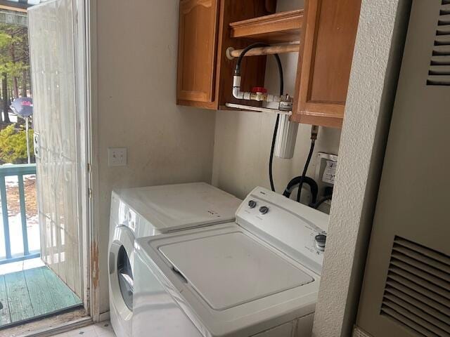 8725 Rocky Mountain Rd, Shingletown, CA 96088 - washroom featuring a wealth of natural light, cabinet space, and washer and clothes dryer
