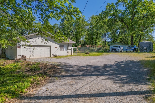 exterior space with driveway, fence, and a garage