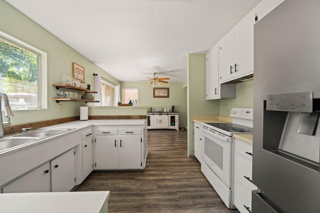 kitchen featuring light countertops, electric stove, a peninsula, stainless steel refrigerator with ice dispenser, and white cabinetry