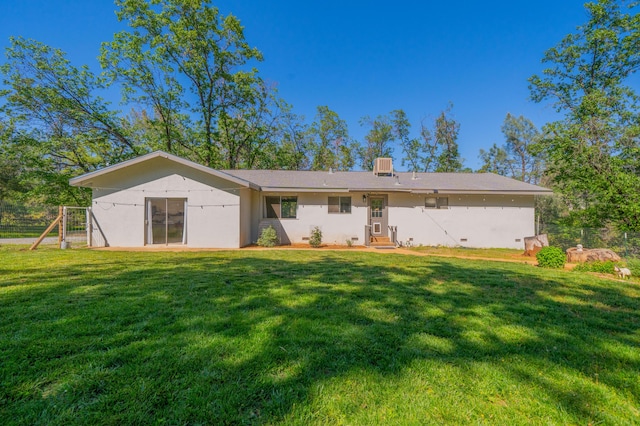 back of property with a lawn