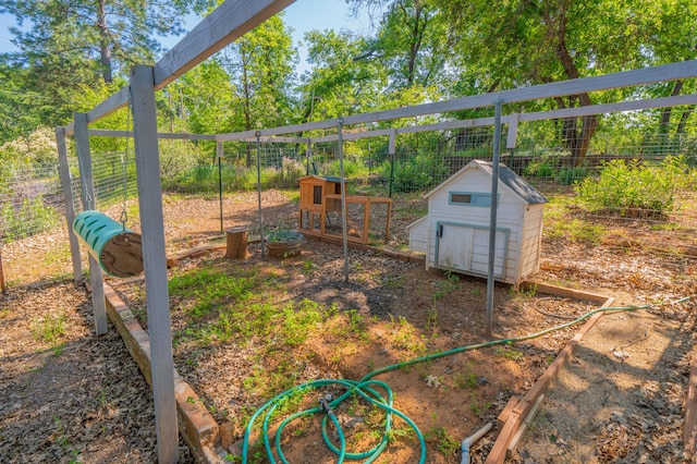 view of yard with an outdoor structure, a storage shed, fence, and exterior structure