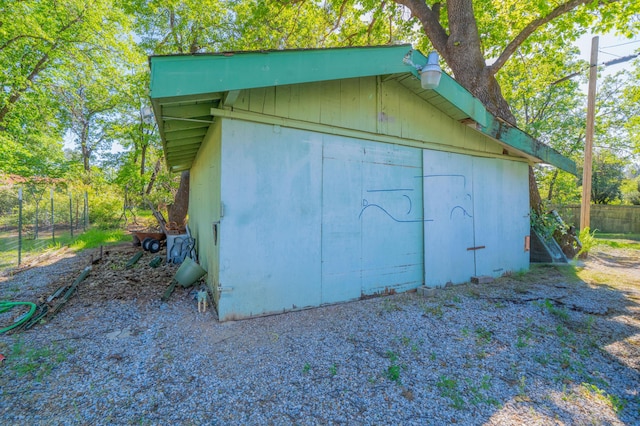 view of outbuilding with fence