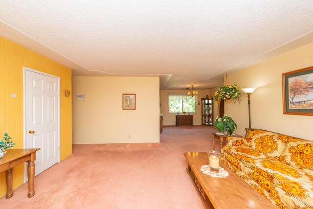 carpeted living area with a textured ceiling and a chandelier
