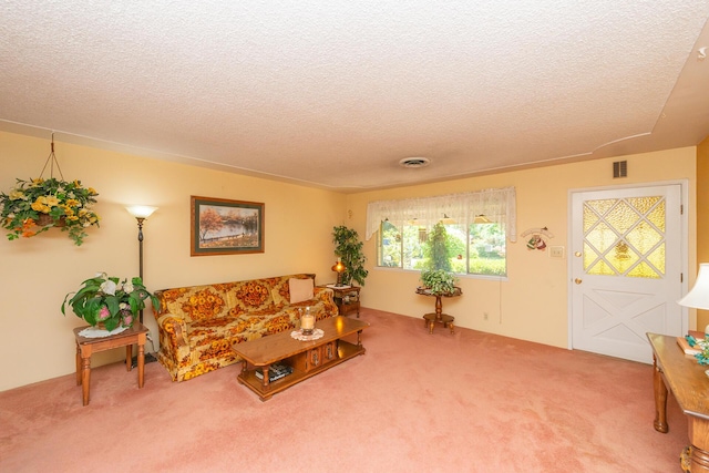 living room with a textured ceiling, visible vents, and carpet flooring