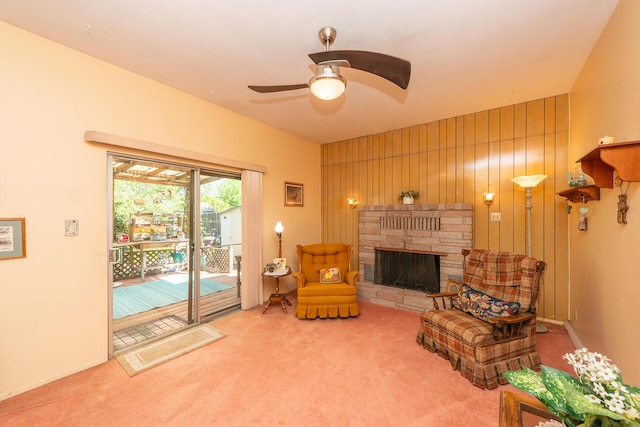 sitting room with carpet flooring, a fireplace, and ceiling fan