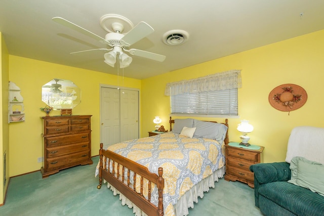 carpeted bedroom with a closet, visible vents, and ceiling fan