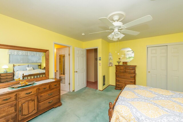 bedroom with light colored carpet, ceiling fan, connected bathroom, and a closet