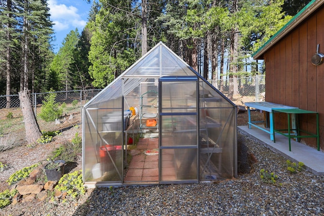 view of greenhouse featuring fence