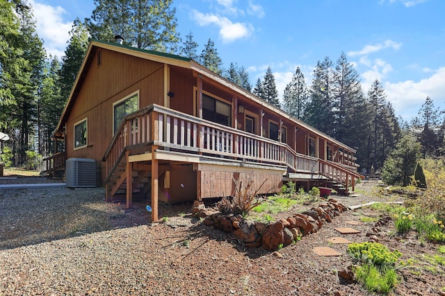 view of front facade with a wooden deck, central AC, and stairs