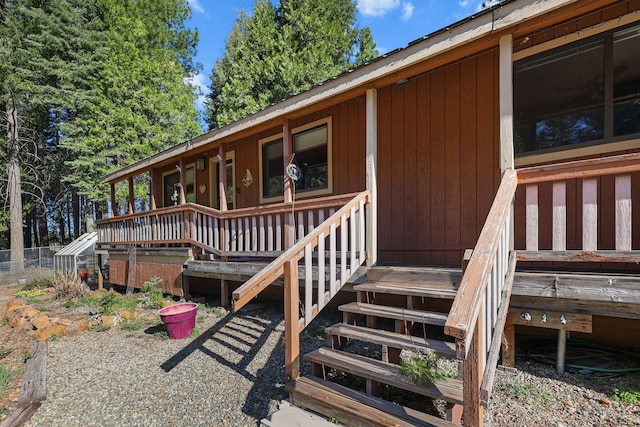 property entrance featuring fence and a deck