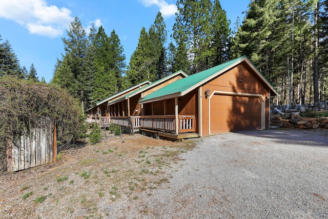 rustic home with a detached garage and metal roof