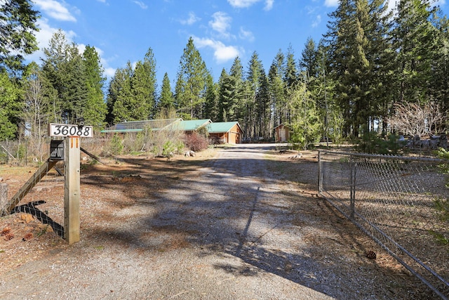 view of road featuring a gated entry and dirt driveway