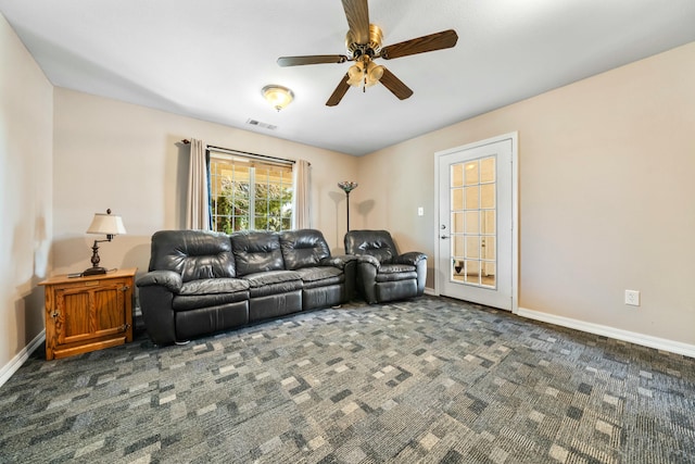 living room featuring baseboards, a ceiling fan, carpet flooring, and visible vents