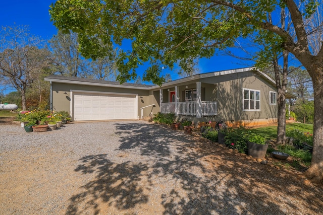 ranch-style house with a garage, driveway, and a porch