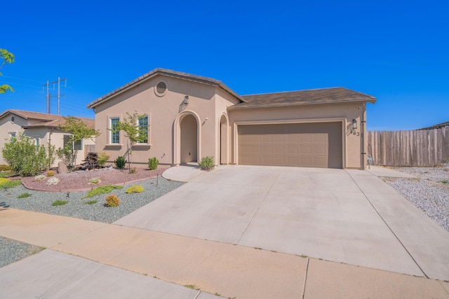 4631 Pleasant Hills Dr, Anderson, CA 96007 - mediterranean / spanish-style house featuring a garage, driveway, stucco siding, and fence