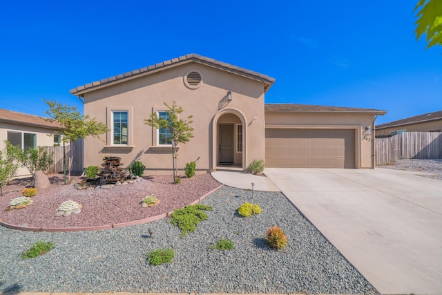 4631 Pleasant Hills Dr, Anderson, CA 96007 - mediterranean / spanish-style house featuring an attached garage, concrete driveway, fence, and stucco siding