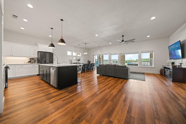 4631 Pleasant Hills Dr, Anderson, CA 96007 - kitchen with black refrigerator with ice dispenser, a ceiling fan, plenty of natural light, open floor plan, and recessed lighting
