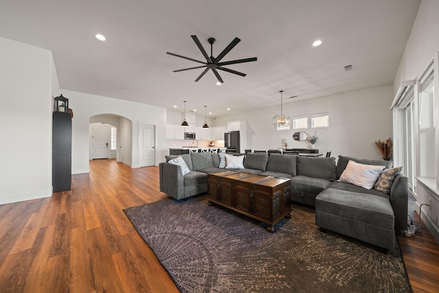 4631 Pleasant Hills Dr, Anderson, CA 96007 - living area featuring arched walkways, wood finished floors, visible vents, and ceiling fan with notable chandelier