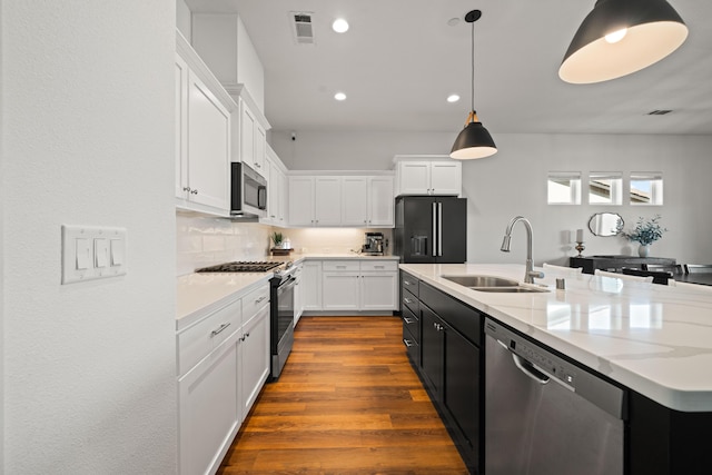 4631 Pleasant Hills Dr, Anderson, CA 96007 - kitchen with a sink, a kitchen island with sink, appliances with stainless steel finishes, white cabinetry, and visible vents