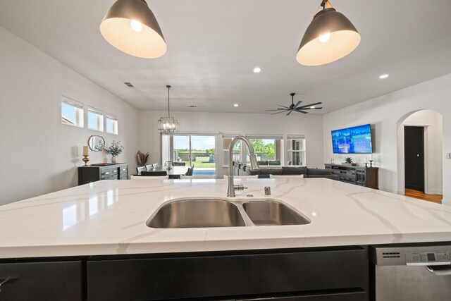 4631 Pleasant Hills Dr, Anderson, CA 96007 - kitchen featuring dishwasher, a sink, a kitchen island with sink, and dark cabinetry