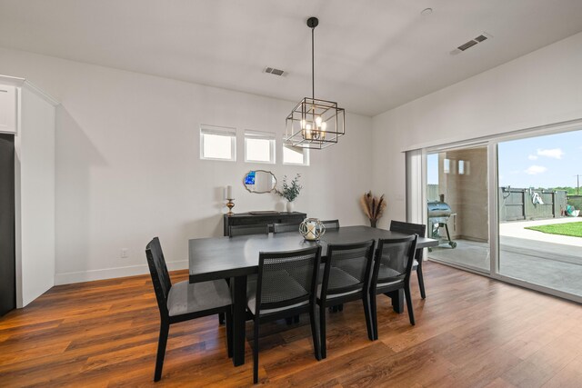 4631 Pleasant Hills Dr, Anderson, CA 96007 - dining room featuring a healthy amount of sunlight, wood finished floors, a chandelier, and visible vents