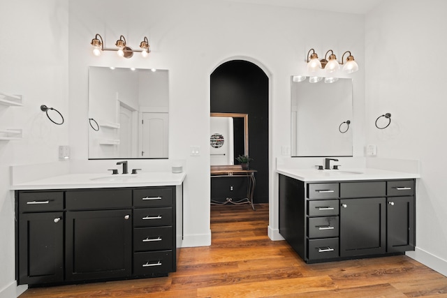 4631 Pleasant Hills Dr, Anderson, CA 96007 - bathroom featuring two vanities, wood finished floors, and a sink