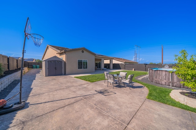 4631 Pleasant Hills Dr, Anderson, CA 96007 - back of house featuring a storage shed, an outbuilding, a patio, and a fenced backyard