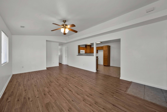22496 Rio Alto Dr, Cottonwood, CA 96022 - unfurnished living room with dark wood finished floors, ceiling fan, and baseboards