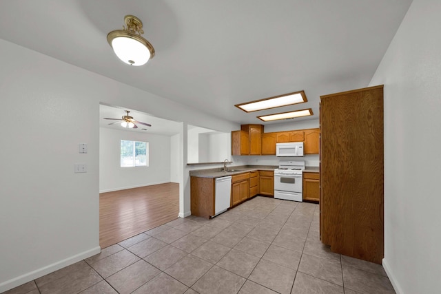 22496 Rio Alto Dr, Cottonwood, CA 96022 - kitchen featuring white appliances, a sink, light tile patterned flooring, and baseboards