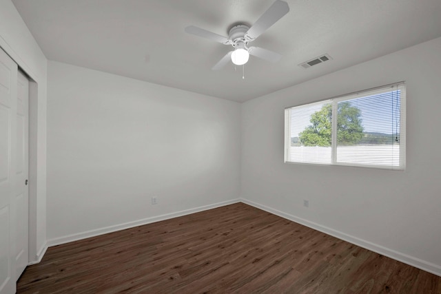22496 Rio Alto Dr, Cottonwood, CA 96022 - unfurnished bedroom featuring dark wood-style flooring, baseboards, a closet, and a ceiling fan