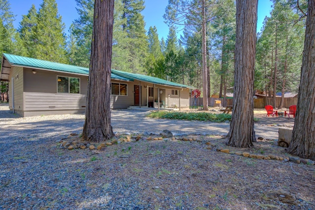 ranch-style house featuring fence, a patio area, and metal roof