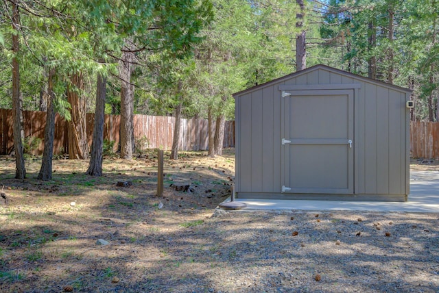 view of shed featuring fence