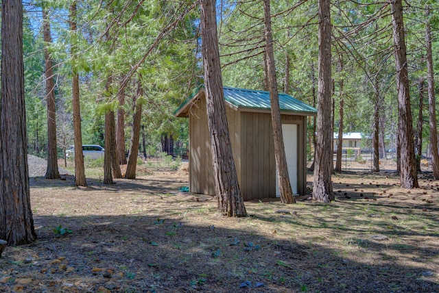 view of shed featuring a forest view