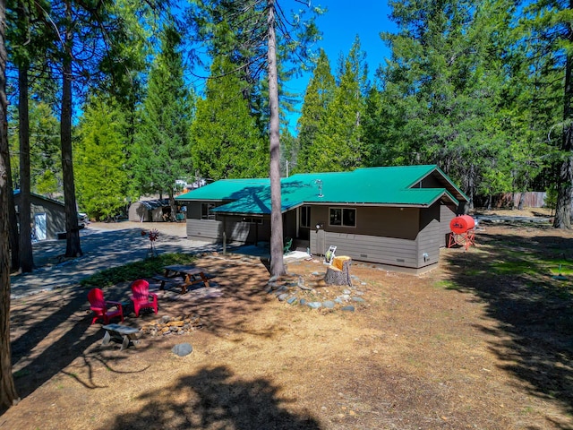 rear view of property featuring metal roof