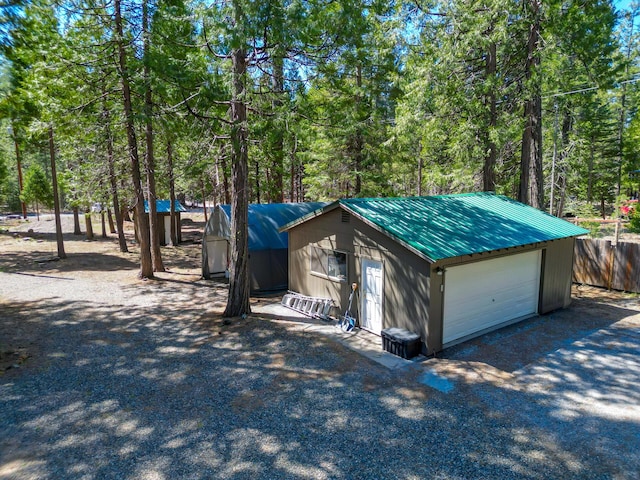 detached garage with a wooded view