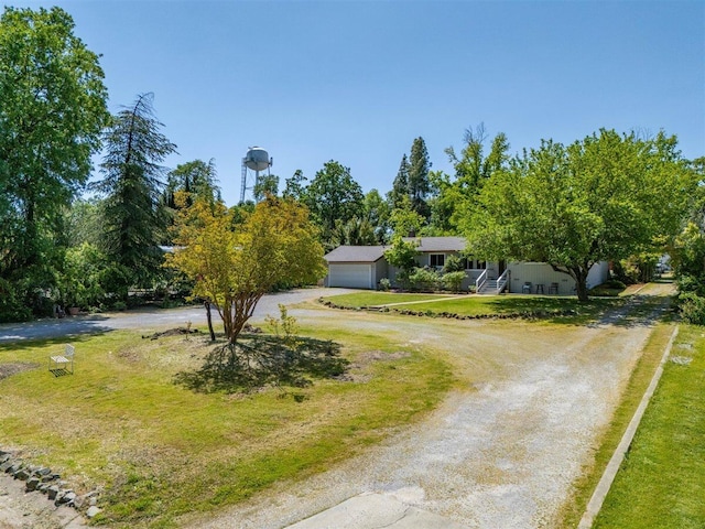 7090 Rio Rancho Rd, Anderson, CA 96007 - view of front of house with an attached garage, a front lawn, and dirt driveway
