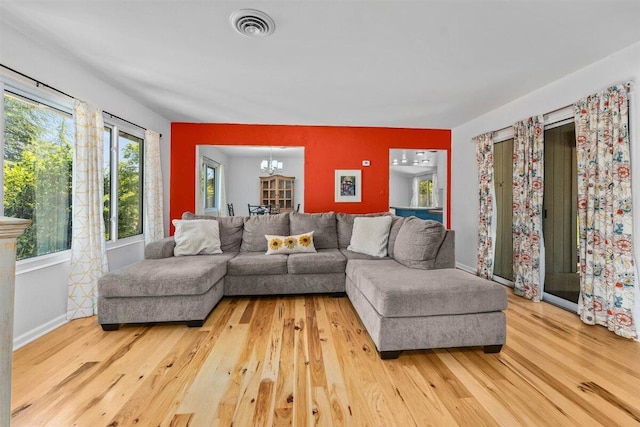 7090 Rio Rancho Rd, Anderson, CA 96007 - living room featuring visible vents, baseboards, wood finished floors, and a notable chandelier