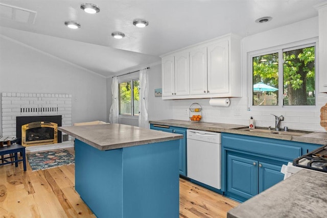 7090 Rio Rancho Rd, Anderson, CA 96007 - kitchen with vaulted ceiling, white dishwasher, light wood-type flooring, blue cabinetry, and visible vents