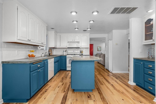 7090 Rio Rancho Rd, Anderson, CA 96007 - kitchen featuring light wood-type flooring, visible vents, white cabinetry, white appliances, and blue cabinetry