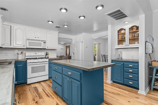 7090 Rio Rancho Rd, Anderson, CA 96007 - kitchen with visible vents, white appliances, white cabinetry, and blue cabinetry