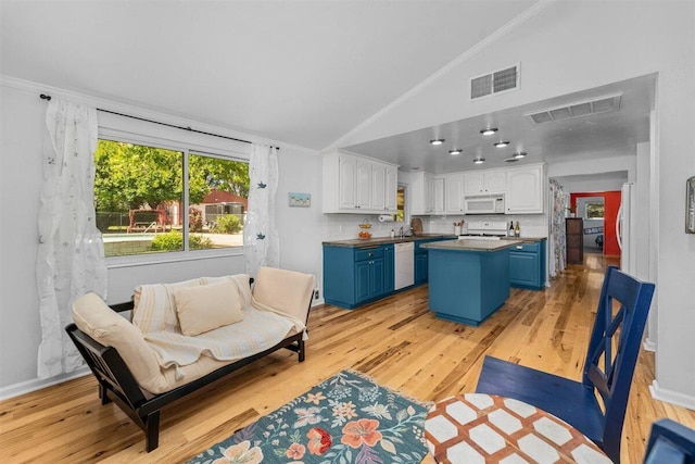 7090 Rio Rancho Rd, Anderson, CA 96007 - living area featuring vaulted ceiling, visible vents, a healthy amount of sunlight, and light wood-style flooring