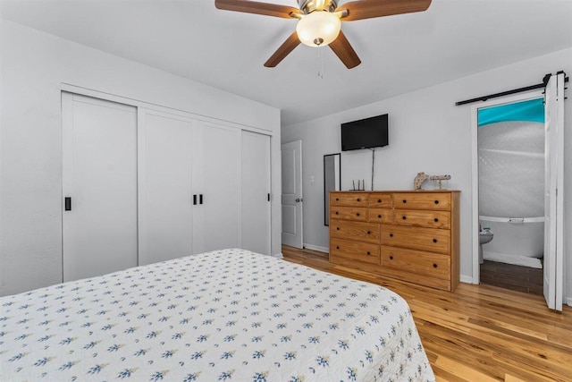 7090 Rio Rancho Rd, Anderson, CA 96007 - bedroom with wood finished floors, a closet, baseboards, ceiling fan, and ensuite bathroom