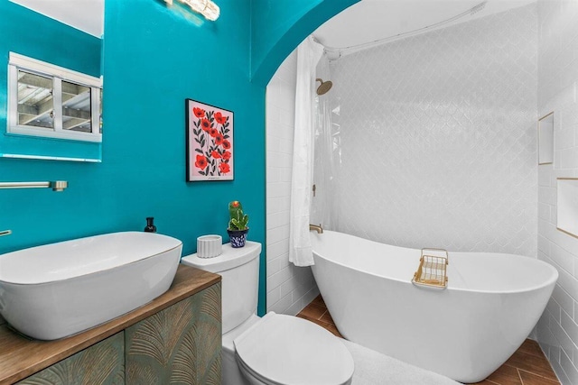 7090 Rio Rancho Rd, Anderson, CA 96007 - bathroom featuring tile walls, a shower, a freestanding bath, and toilet