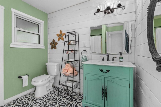 7090 Rio Rancho Rd, Anderson, CA 96007 - bathroom with baseboards, wooden walls, vanity, and toilet
