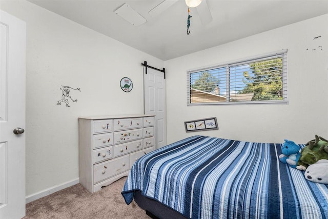 7090 Rio Rancho Rd, Anderson, CA 96007 - bedroom with a barn door, carpet floors, ceiling fan, and baseboards
