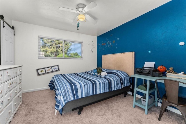 7090 Rio Rancho Rd, Anderson, CA 96007 - bedroom featuring a barn door, carpet flooring, baseboards, and ceiling fan