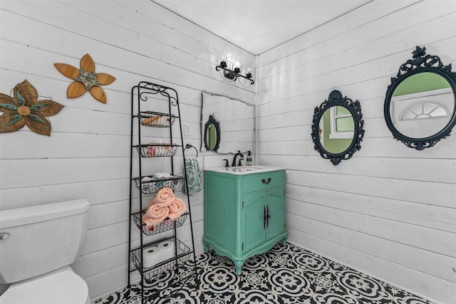 7090 Rio Rancho Rd, Anderson, CA 96007 - bathroom featuring wood walls, toilet, and vanity