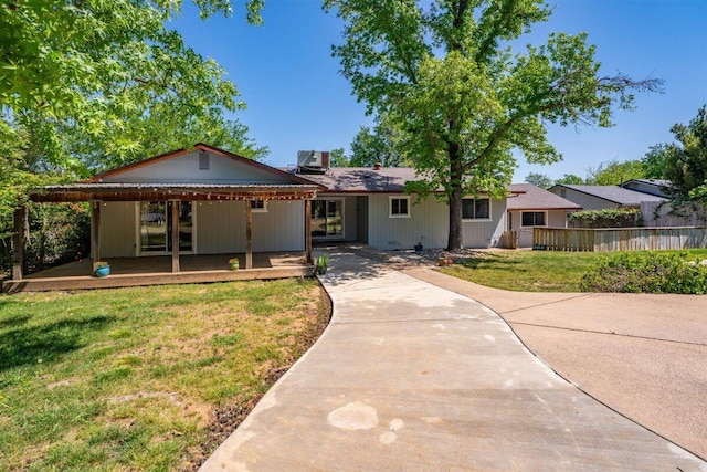 7090 Rio Rancho Rd, Anderson, CA 96007 - view of front facade featuring a wooden deck, a front yard, and fence