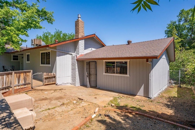 7090 Rio Rancho Rd, Anderson, CA 96007 - rear view of property featuring roof with shingles, a gate, a chimney, fence, and a patio