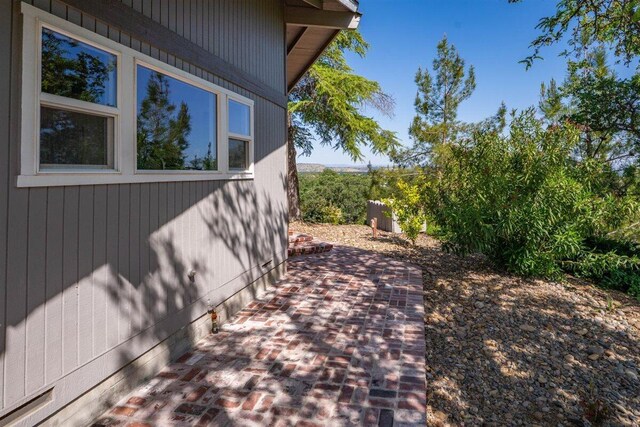 view of property exterior with a patio area